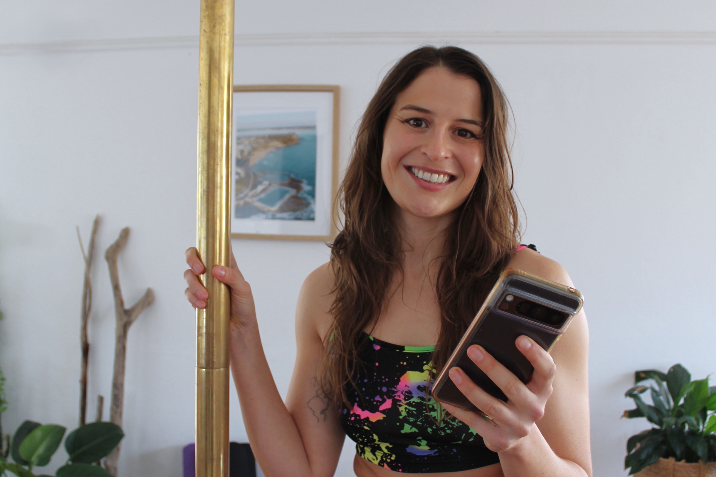 Dance studio owner smiling at her phone