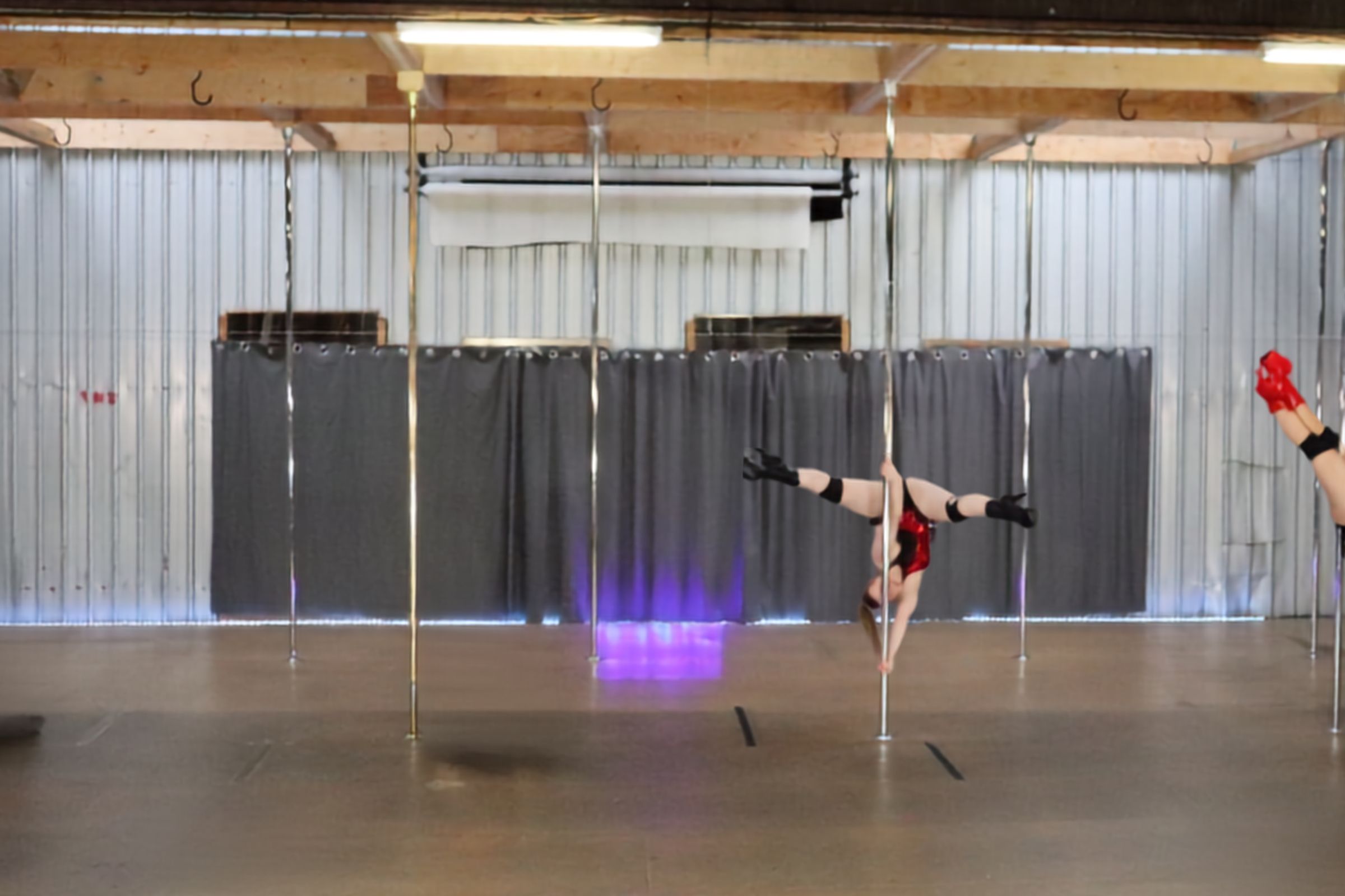Pole dancer in an empty dance studio